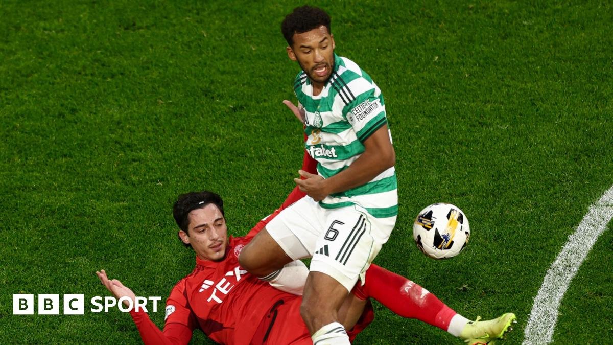 Aberdeen's Marko Lazetic (L) takes a shot but it's blocked by Celtic's Auston Trusty